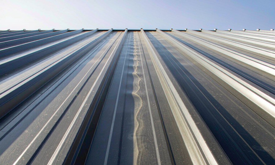 Oil Canning: Why a Flat Roof Panel Turns Wavy, and What Actually Fixes It